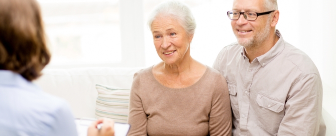 retirement planning older couple sitting with an adviser