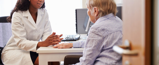 Senior Patient Having Consultation With Doctor In Office