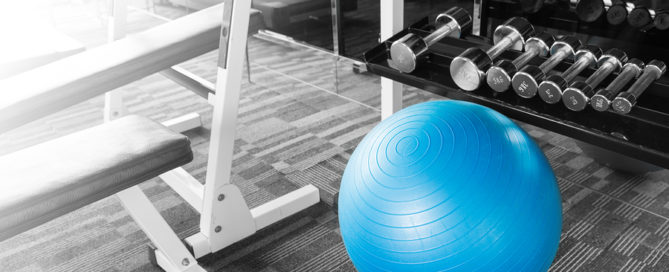 Fitness gym with blue gym ball dumbell and other excercise equipment