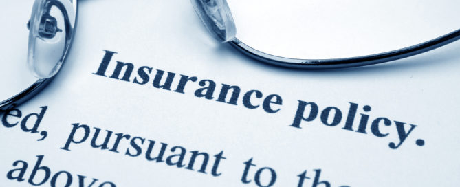 Close up of glasses on Insurance policy contract language