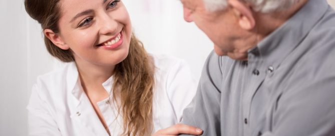 smiling nurse assisting senior man
