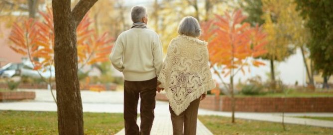 Older couple walking holding hands in the fall long-term care average stay