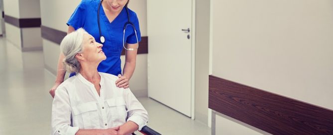 Young nurse pushing an older woman in a wheelchair