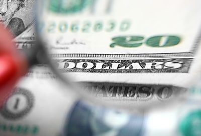 close up of a 20 dollar bill through a magnifying glass