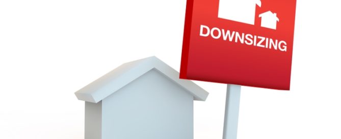 red sign on a white background with house concept of downsizing