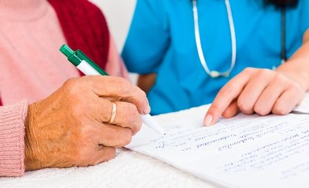 woman signing a Contract With Nursing Home