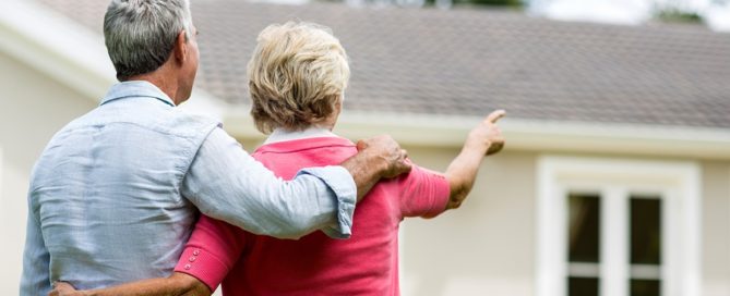 senior couple looking at house