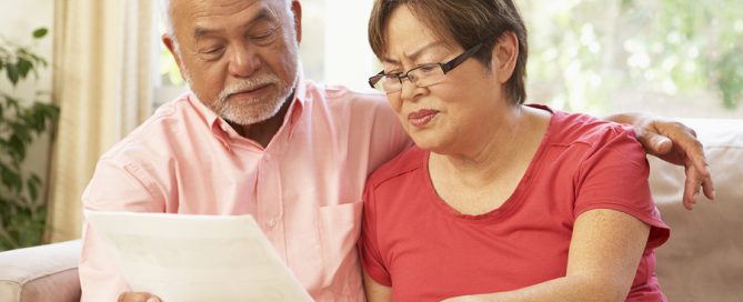 refundable CCRC entry fees Senior Couple Discussing Document At Home