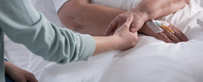 hospice care older woman in bed having support of her family