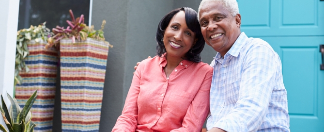 CCRC age requirements older couple sitting on outside house steps