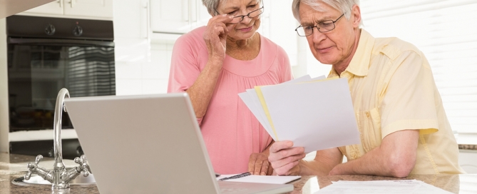 choosing a CCRC older couple examining documents