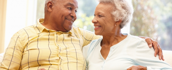 CCRC happy older couple cuddling on a sofa