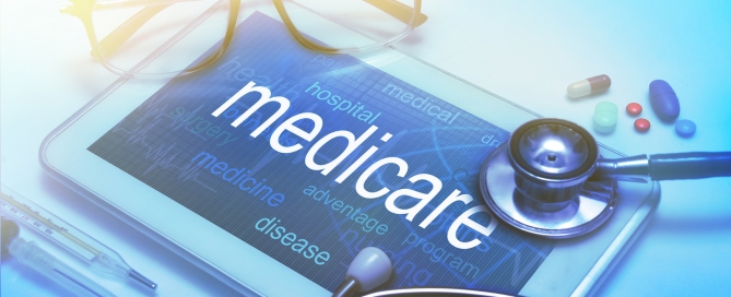 Medicare word on tablet screen with medical equipment on background