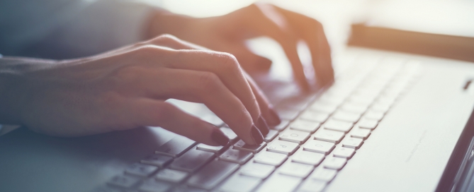 CCRC consumer survey hands on a laptop keyboard