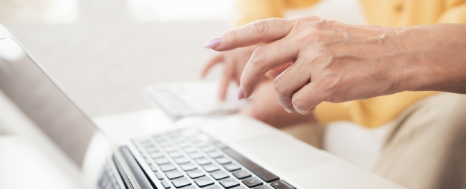 people sitting in front of a laptop.