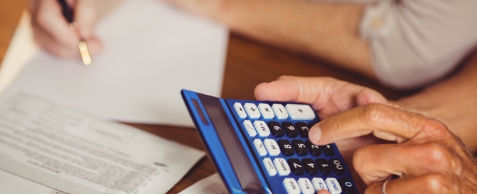 Close up of senior couple calculating CCRC expenses