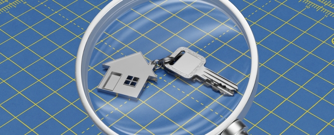 House and keys under magnifying glass as a home search concept
