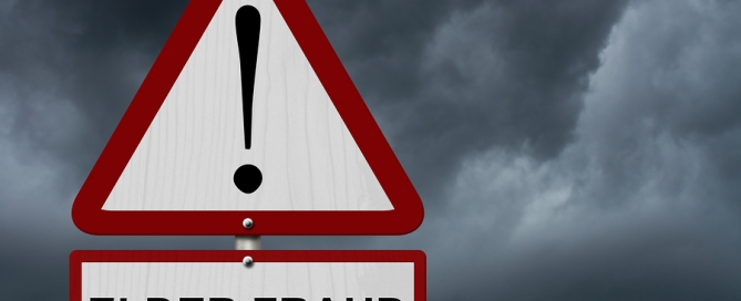 Elder Fraud Caution Sign Red and White Triangle Caution sign with word Elder Fraud with stormy sky background