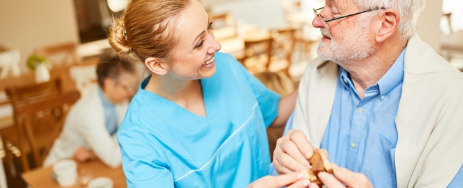 nurse helping a man in a nursing home setting