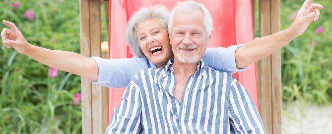 Smiling senior couple at the beach