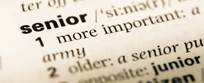 Close up of old English dictionary page with word senior