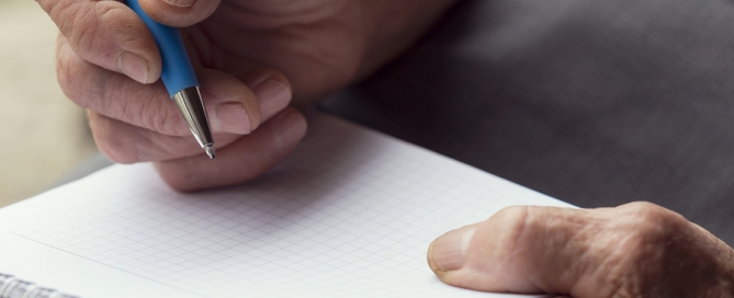 Prospective CCRC Resident Questions Detail of an elderly woman's hands holding a pen and writing a list