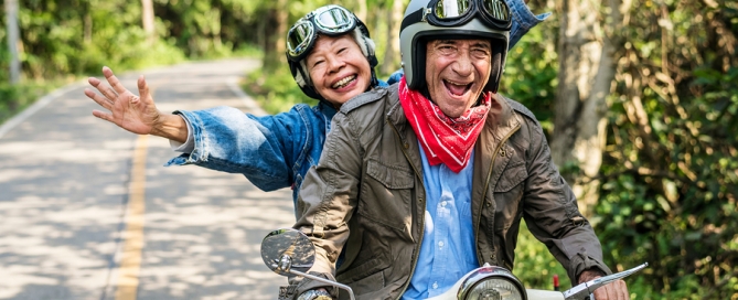 Senior couple riding a scooter; not ready yet for CCRC
