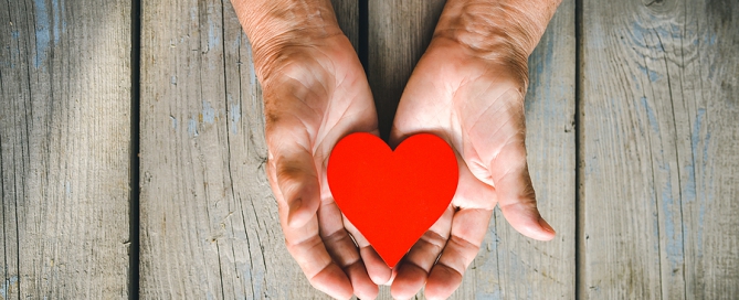 volunteering seniors Elderly Woman Hands On Rustic Wooden Background