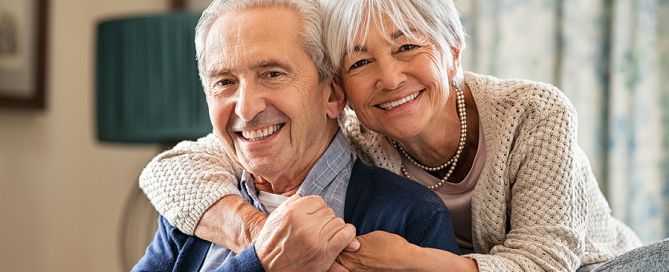 choosing the right retirement community senior couple in living room