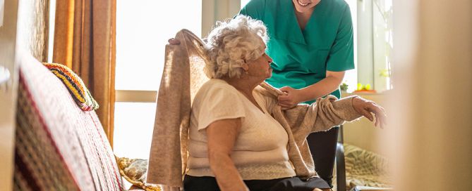 Female nurse taking care of a senior woman at home health care