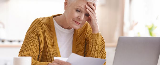single seniors ; single older woman paying bills