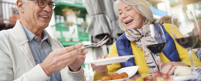senior couple eating tapas outdoors senior living minimum age requirements