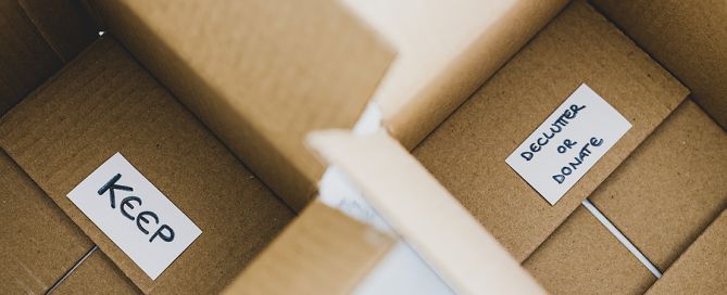 Keep box and donate box; downsizing, keep pile, decluttering, CCRC move