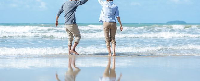 younger CCRC move Senior Couple Dancing On The beach