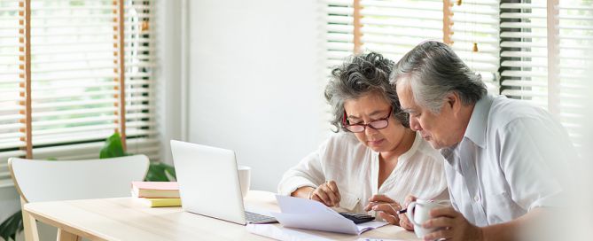 Asian Senior Couple using calculator CCRC sound investment