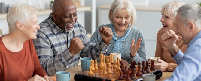 group of senior people playing chess CCRC socialization