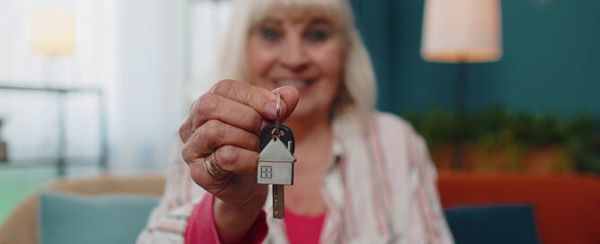 Senior Woman Holds Key To New House smaller CCRC unit