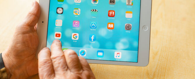 CCRC digital marketing ; Senior Woman Using Apps on iPad digital marketing