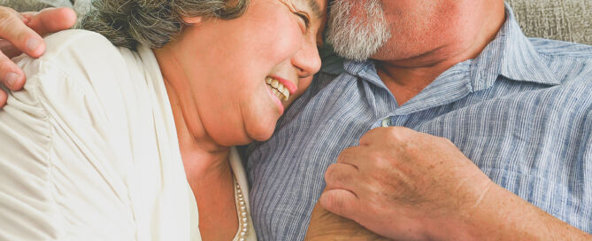 Happy Mature Couple Sitting together how a CCRC keeps couples together as they age