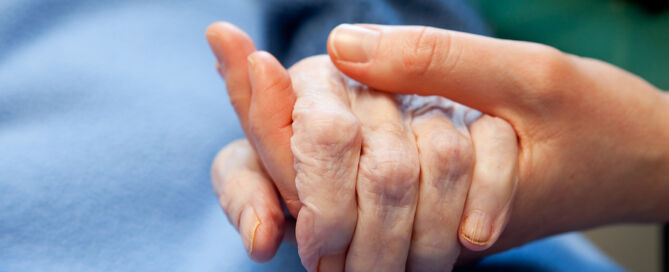 Holding Hand of an Elderly person elder guardianship legal documents ; aging in America