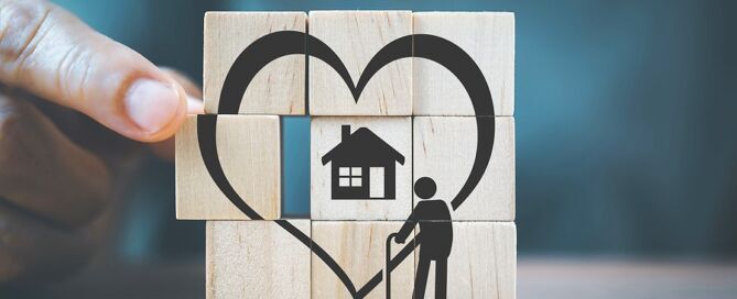 Senior Woman's Hand Completed Heart Shape With Home And Elderly Person Icon remaining in current home