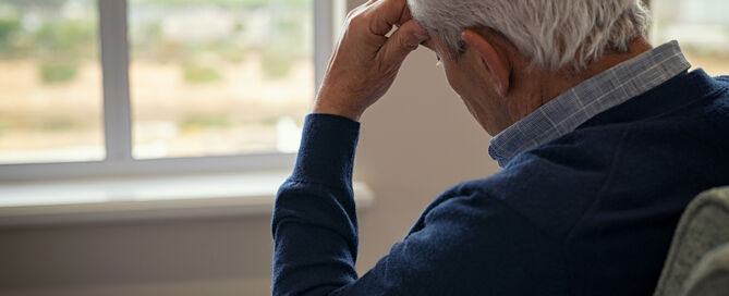old man sitting on armchair in living room senior suicide