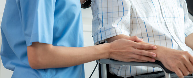 nurse giving support to senior man CCRC healthcare center; adult care