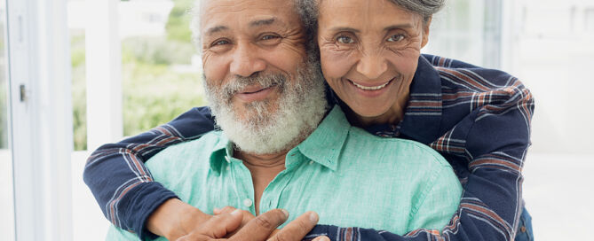 entry fee retirement communities close up of African-American couple hugging