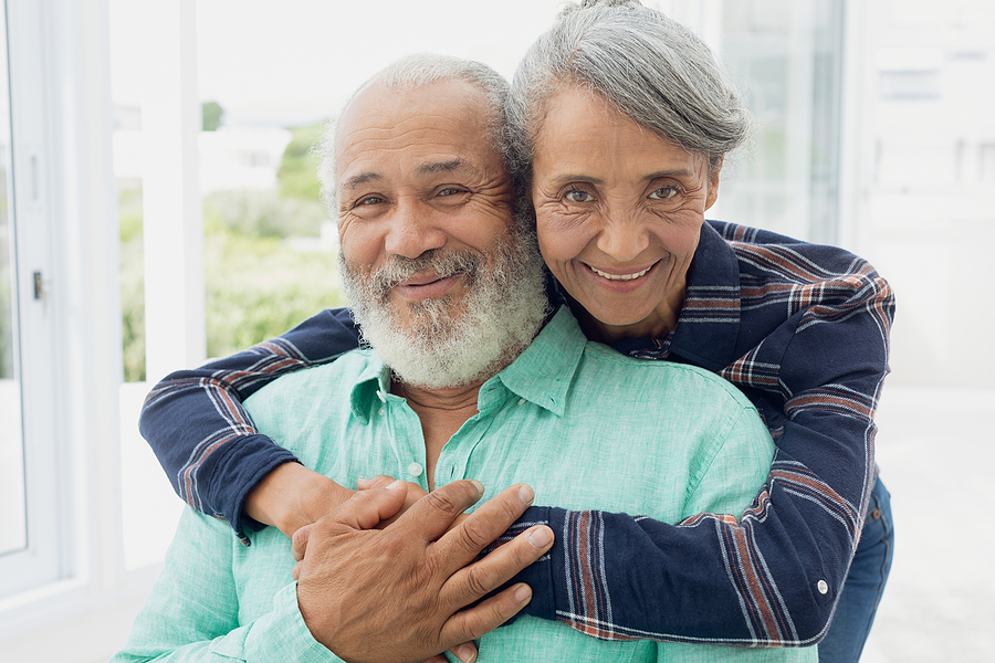 entry fee retirement communities close up of African-American couple hugging