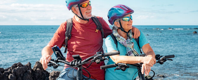 Senior Couple Of Cyclists Wearing Helmets 55 community aging unbounded