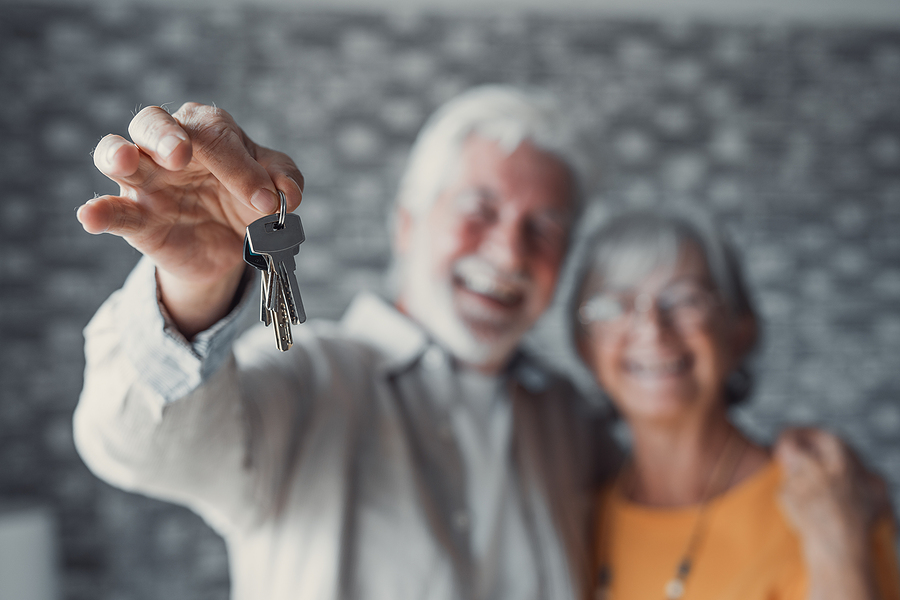 Happy Old Couple Show Keys To Own Apartment over 55 communities