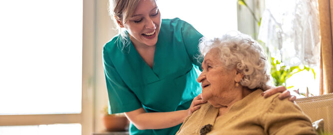 Friendly young woman supporting an elderly lady 55 community 55-plus community intergenerational program