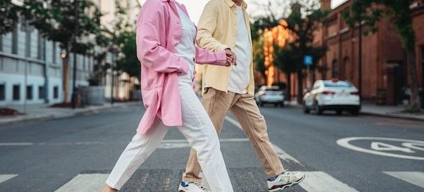 older couple crossing the street; active adult community; active adult living community