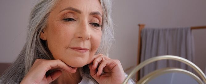 Senior Mature Lady looking in mirror anti-aging ageism